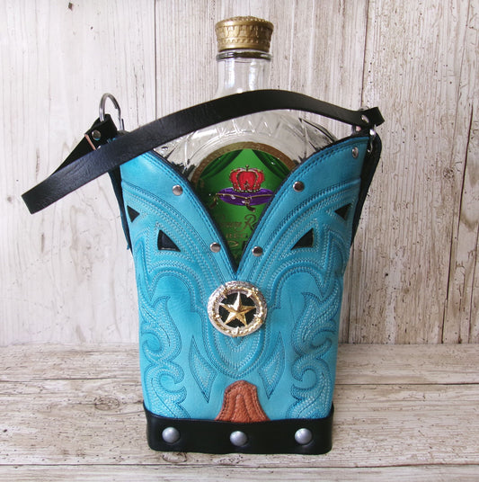 Turquoise cowboy boot-shaped bottle holder with a bottle inside on a wooden surface.