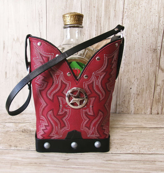 Red leather pouch with cowboy design and bottle inside on a wooden surface