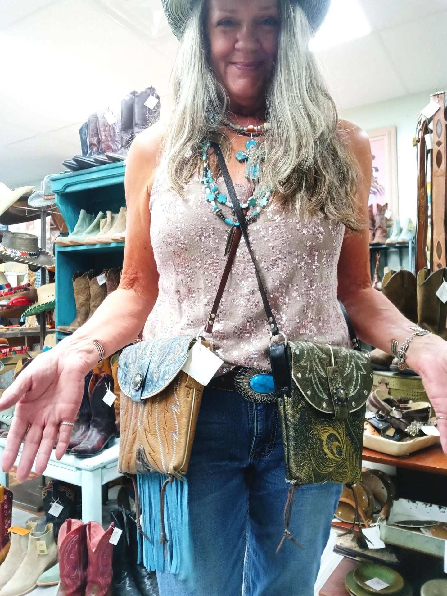 Woman holding two leather bags in a store setting