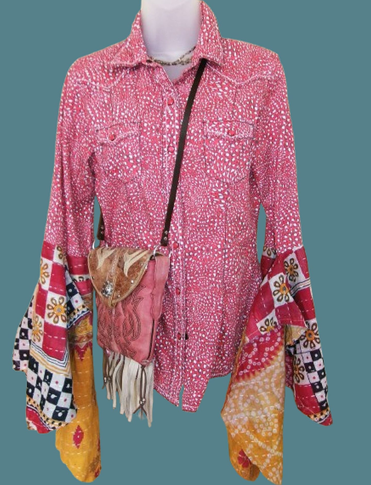 Mannequin wearing a pink patterned shirt with colorful sleeves and a matching handbag on a transparent background