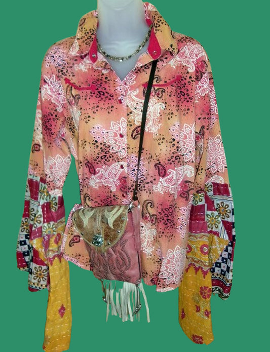 Colorful patterned shirt with a matching handbag on a green background