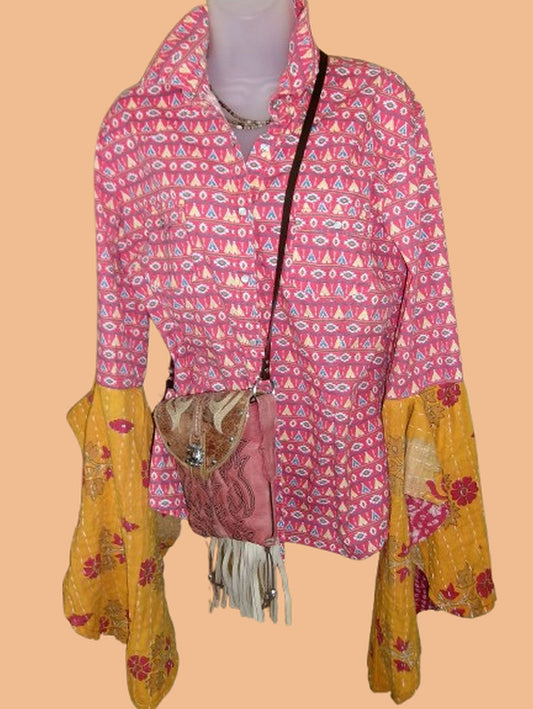 Mannequin wearing a pink patterned jacket with yellow accents on a beige background