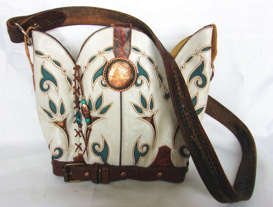Decorative leather bag with intricate patterns and a brown strap on a white background