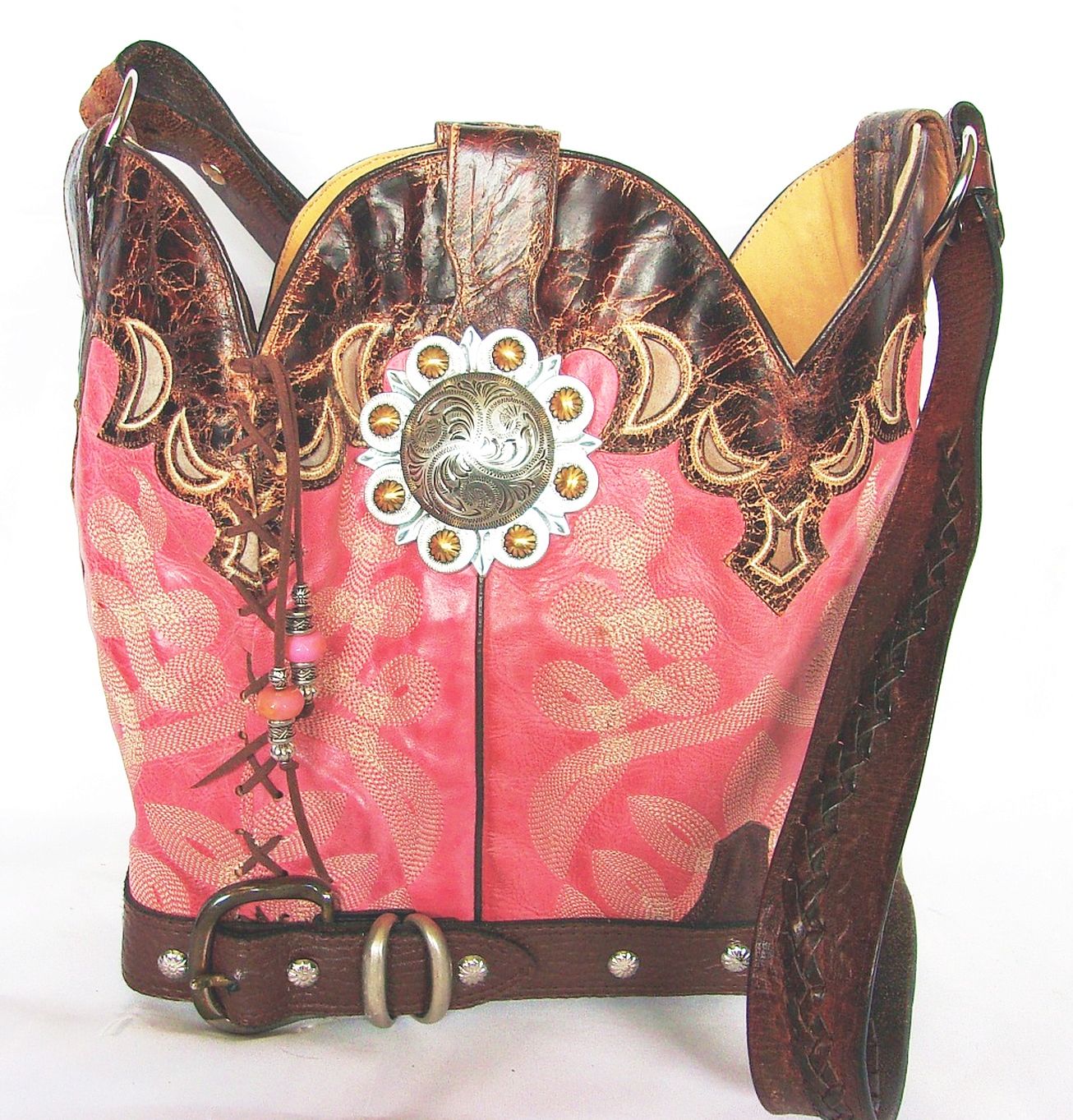 Decorative pink and brown bag with intricate designs and embellishments on a white background