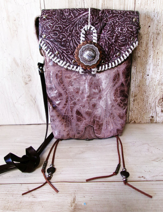 Purple patterned bag with decorative elements on a wooden surface