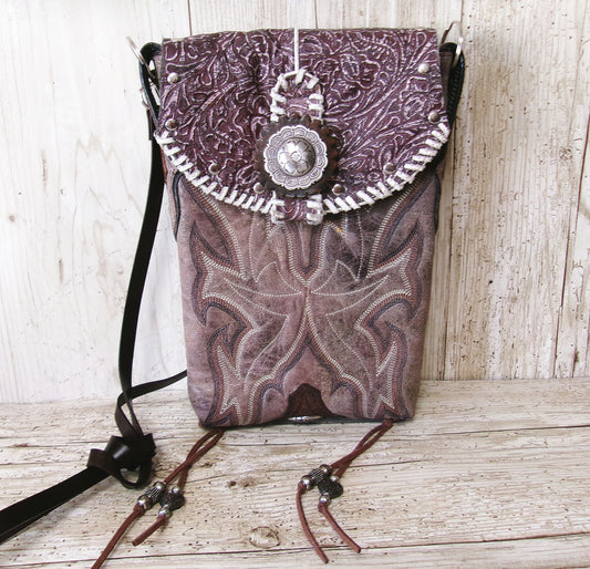 Purple patterned bag with decorative elements on a wooden surface
