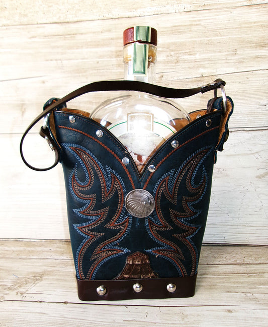 Clear glass bottle with decorative blue leather holder on a wooden surface