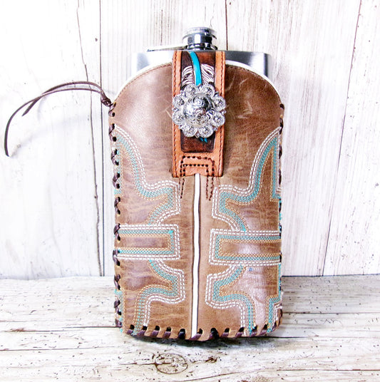 Leather flask with decorative elements on a wooden surface