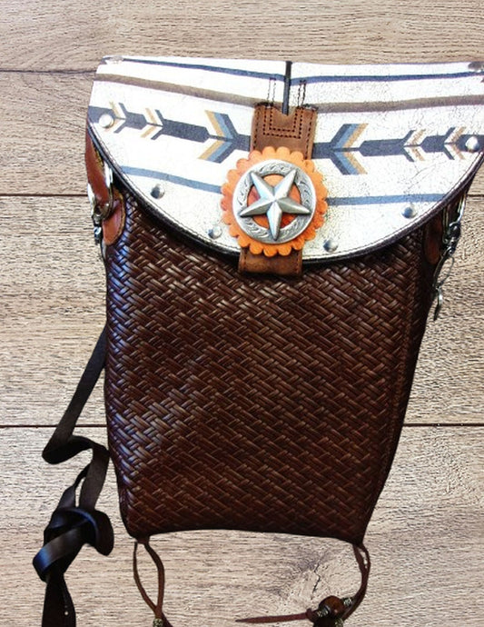 Backpack with decorative star and arrow pattern on a wooden surface