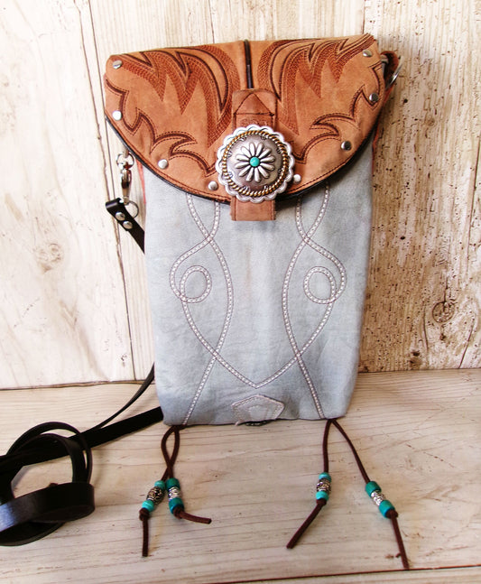 Handbag with decorative flap and beads on a wooden surface