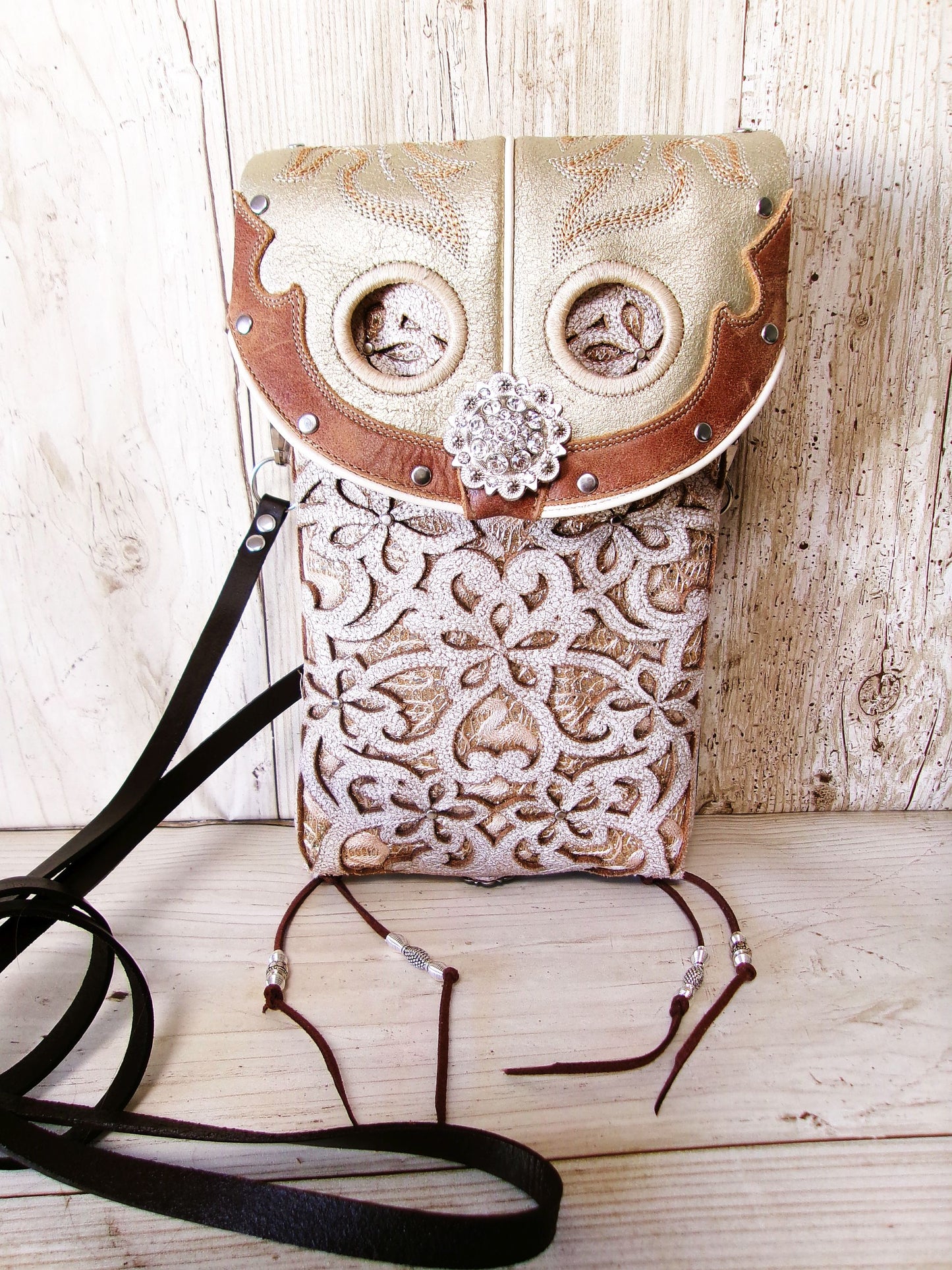 Decorative handbag with intricate patterns on a wooden surface