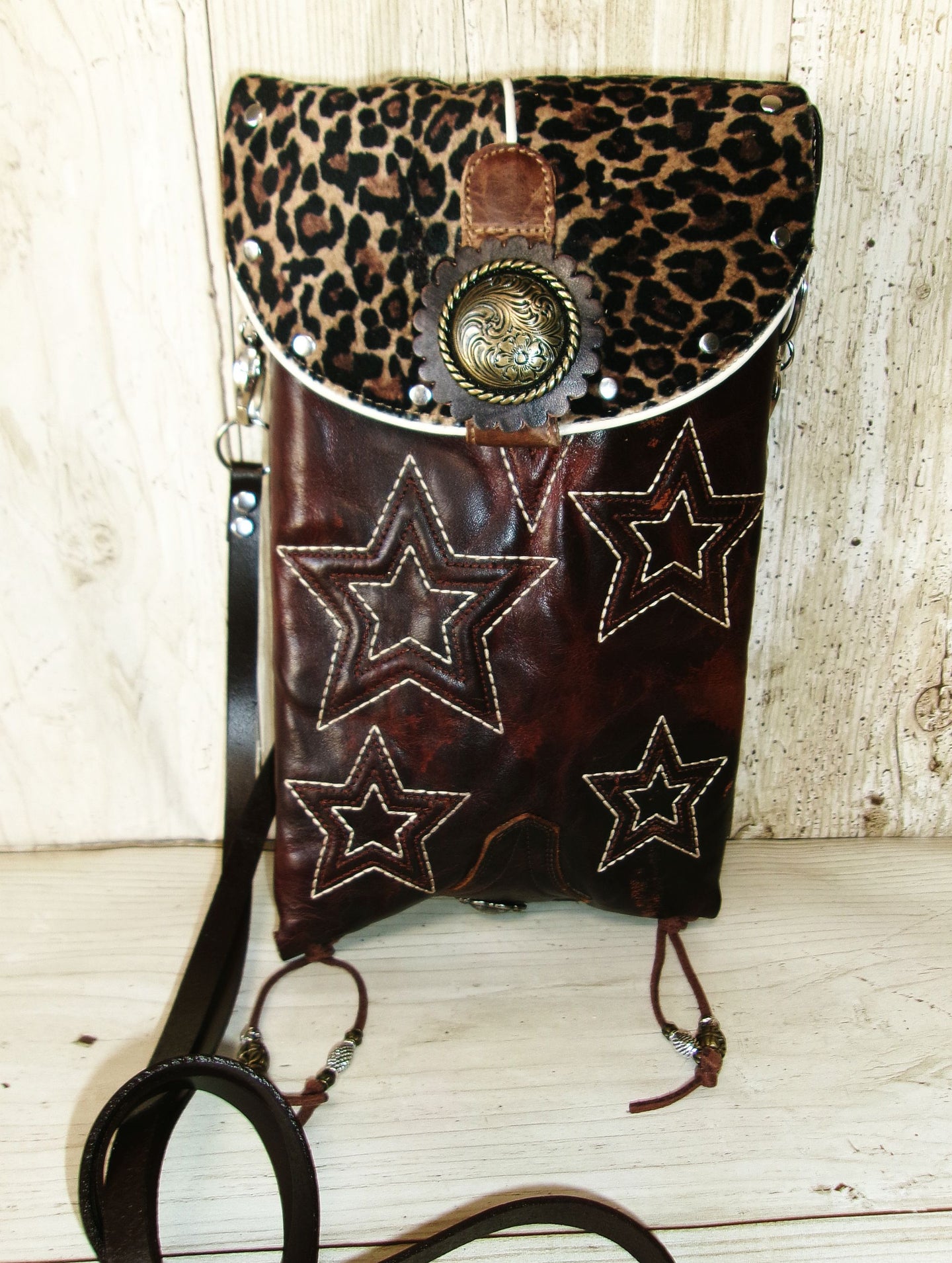Leopard print bag with star designs on a wooden surface