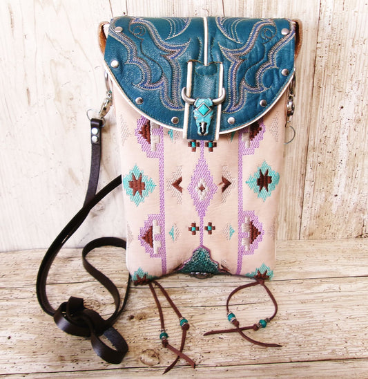 Handbag with blue and beige design on a wooden surface