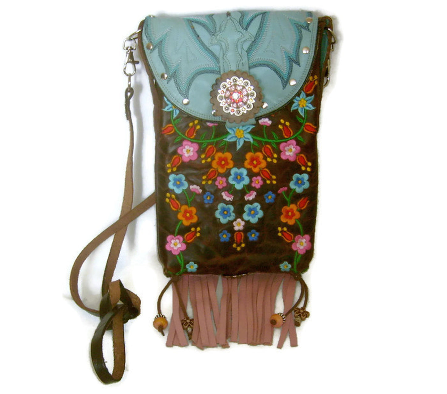 Decorative handbag with floral embroidery and fringe on a white background