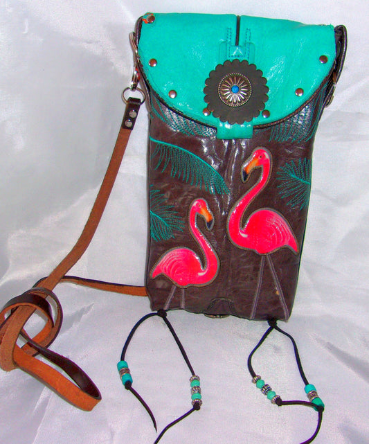 Leather handbag with flamingo design on a white background