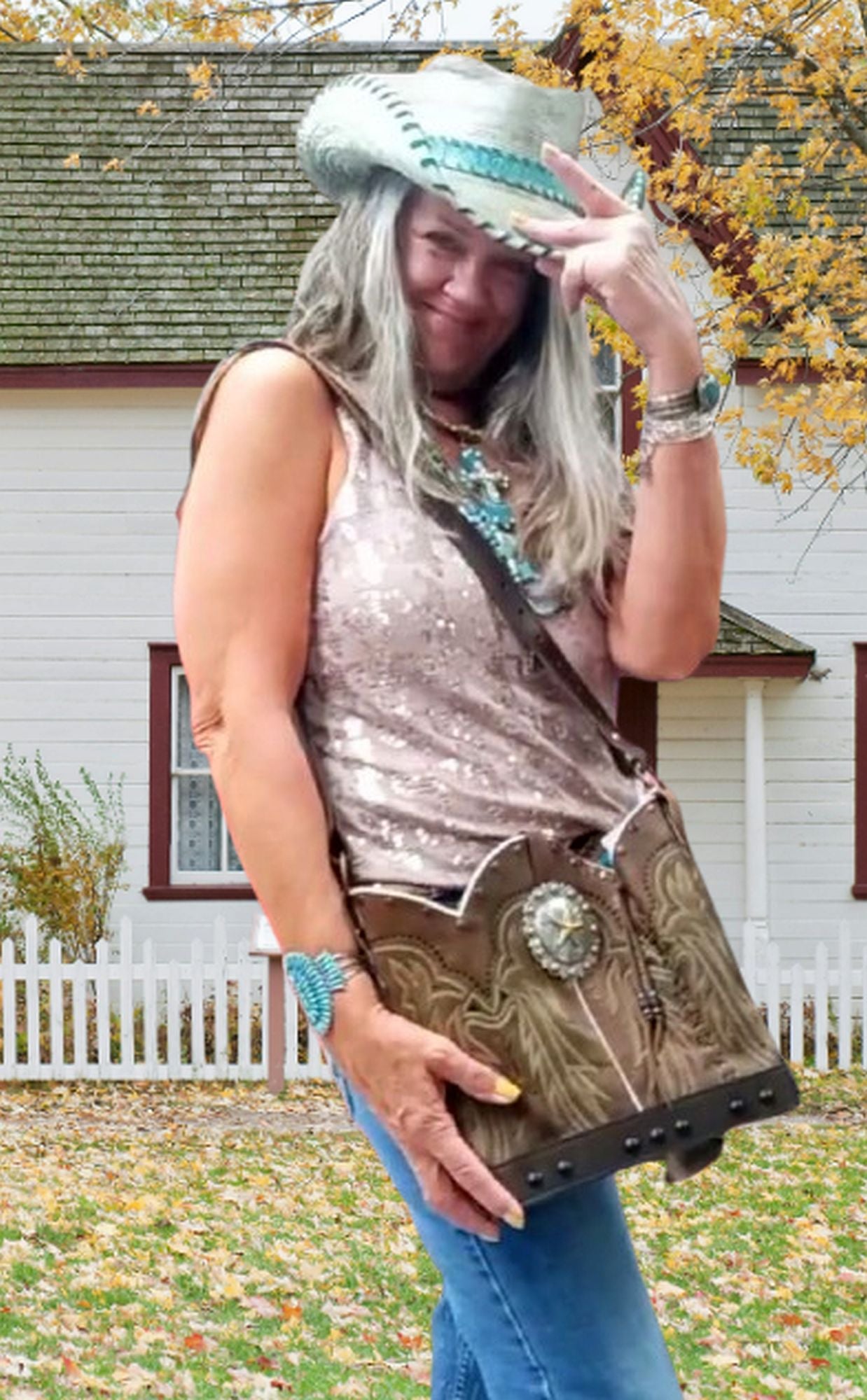 Person holding a decorative bag outdoors with a house and trees in the background