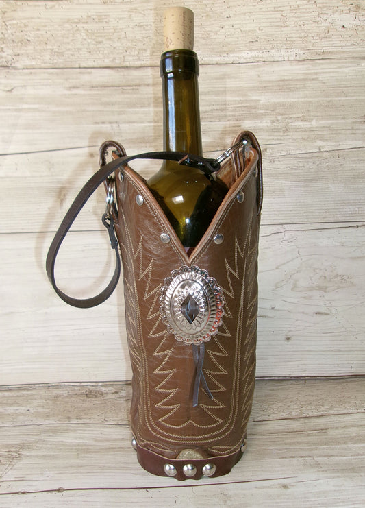 Wine bottle in a decorative leather holder with metallic accents on a wooden surface