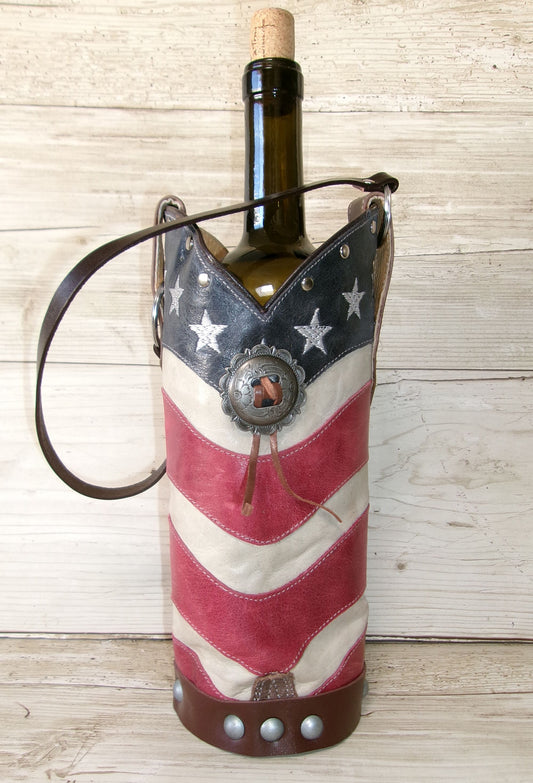 Wine bottle in an American flag-themed holder on a wooden surface