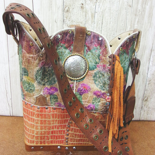 Handbag with floral pattern and decorative elements on a wooden surface