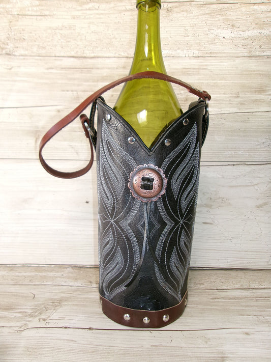 Wine bottle in a decorative holder with intricate patterns on a wooden surface