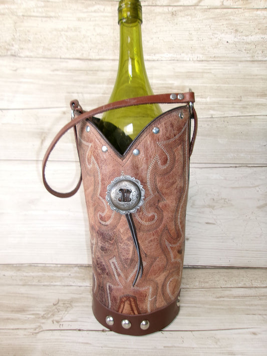 Cowboy boot-shaped wine bottle holder with a bottle of wine on a wooden surface