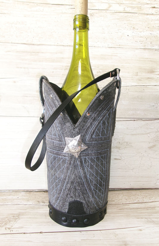 Wine bottle in a decorative holder on a wooden surface