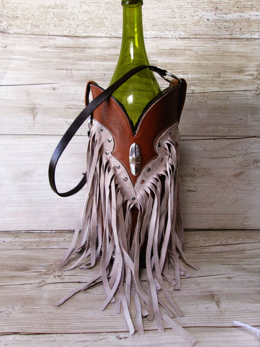 Bottle holder with fringes and leather details on a wooden surface
