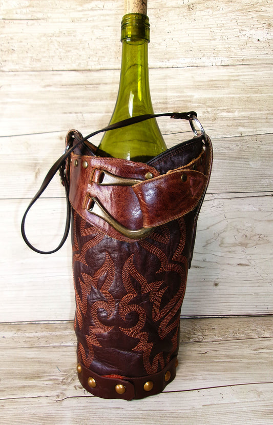 Wine bottle in a decorative leather holder on a wooden surface