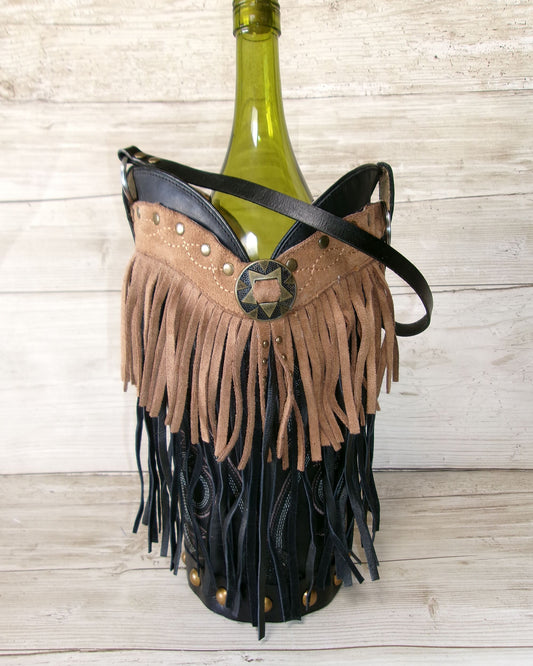 Fringe wine bottle holder with a green wine bottle on a wooden surface